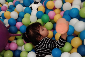 kid playing in a ball pit
